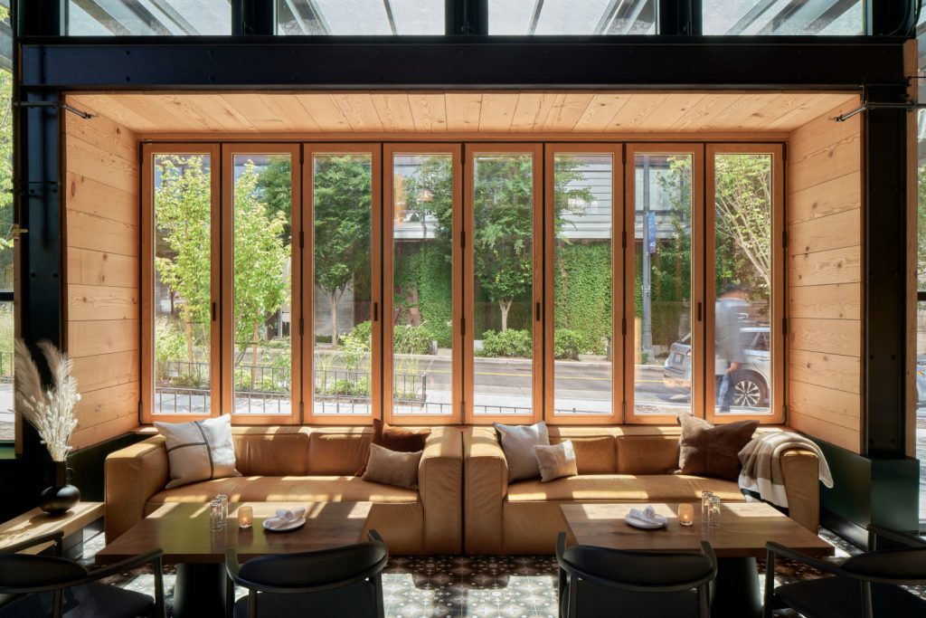 Spacious restaurant corner with large windows offering a bright, airy atmosphere.