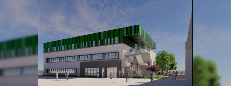 Modern multi-story building with green striped rooftop, outdoor staircase, and people gathered in a landscaped plaza under a blue sky.