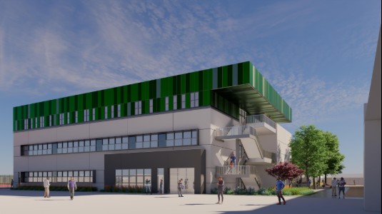 Modern multi-story building with green striped rooftop, outdoor staircase, and people gathered in a landscaped plaza under a blue sky.