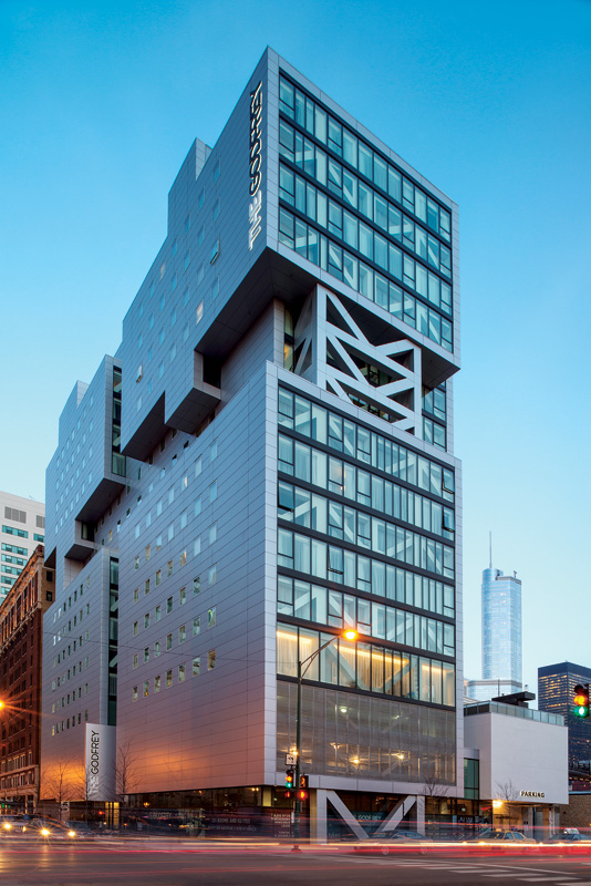 Modern building with a unique geometric design and large glass windows, featuring the name "Goodfrey" prominently displayed.