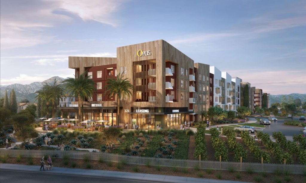 A modern apartment complex named "Opus" surrounded by landscaped gardens and mountains, featuring outdoor seating areas and people walking.