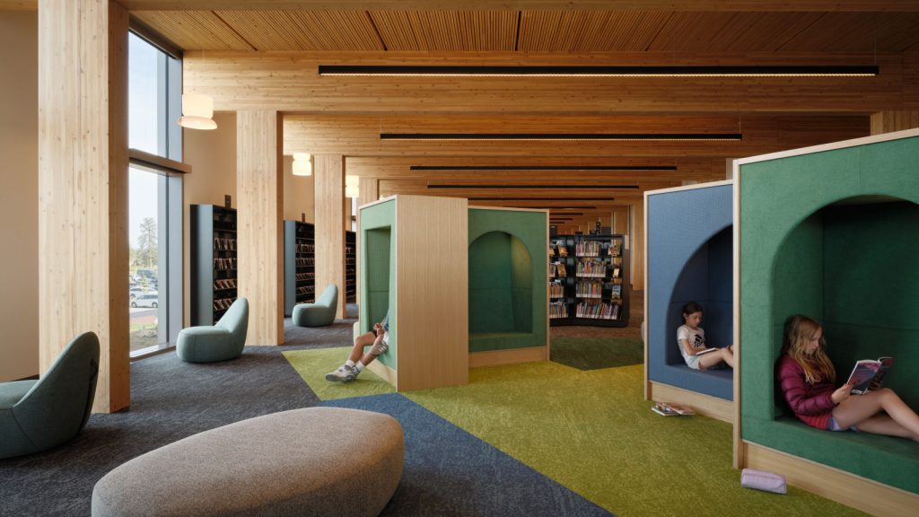 Modern wood-paneled library with colorful carpet, bookshelves, curved lounge seating, and children reading in arched green and blue booths.
